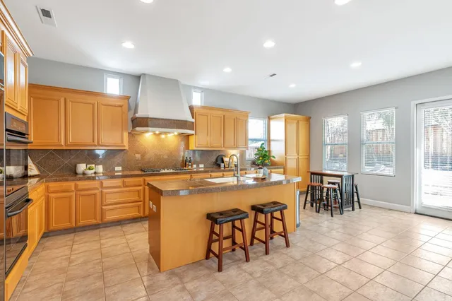 a kitchen with appliances a sink a counter top space and cabinets