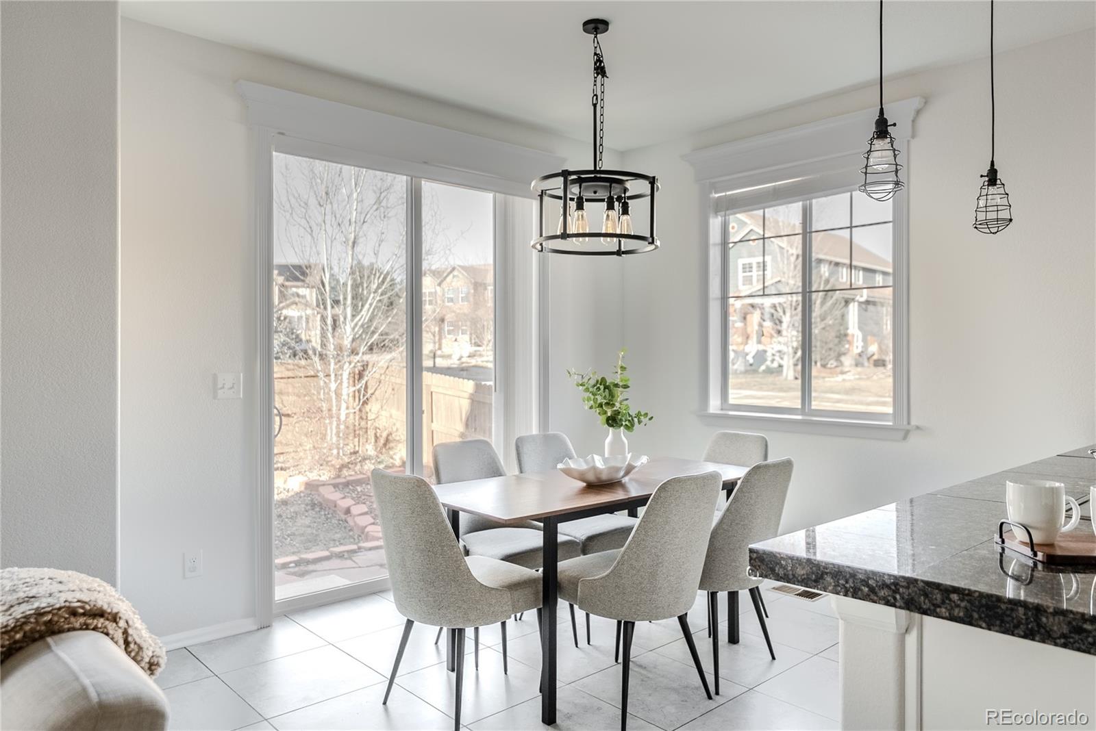 602 Mathews Way Erie, CO 80516 - Photo 11 of 50 a view of a dining room with furniture window and outside view
