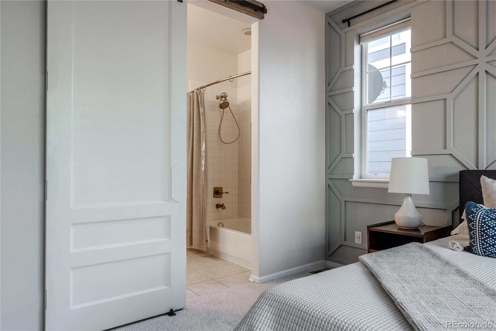 602 Mathews Way Erie, CO 80516 - Photo 20 of 50 a bedroom with a bed and a window