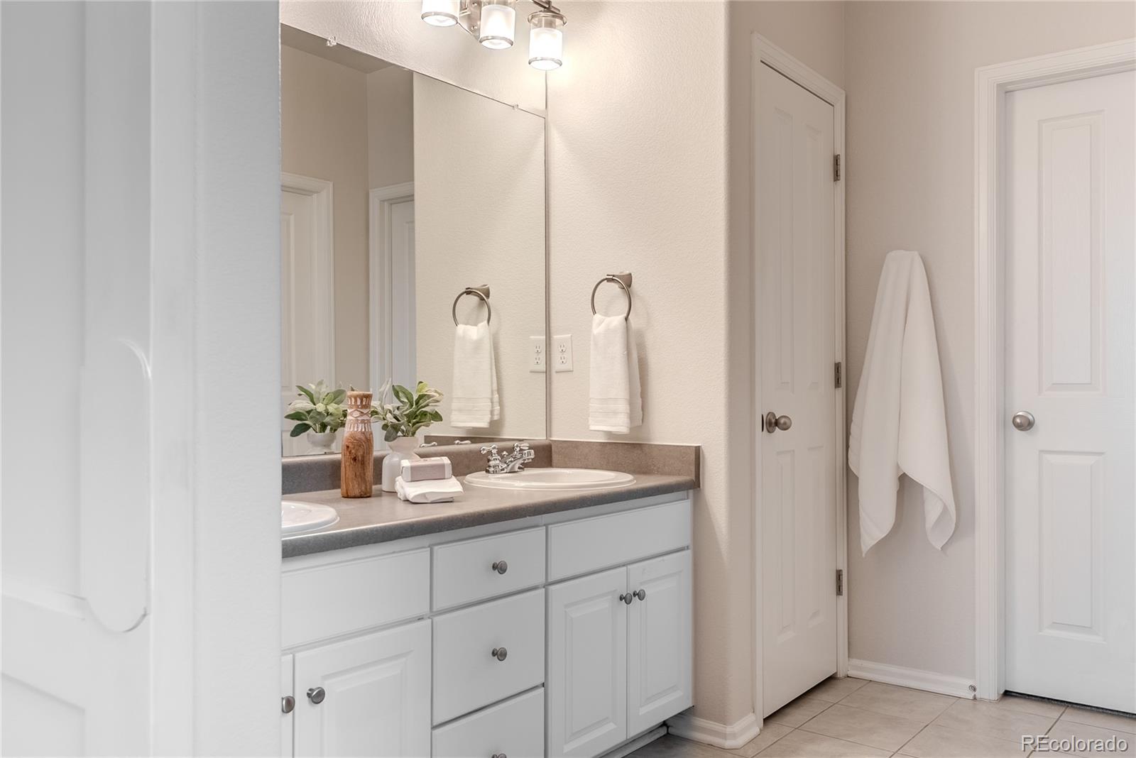602 Mathews Way Erie, CO 80516 - Photo 22 of 50 a bathroom with a double vanity sink and a mirror