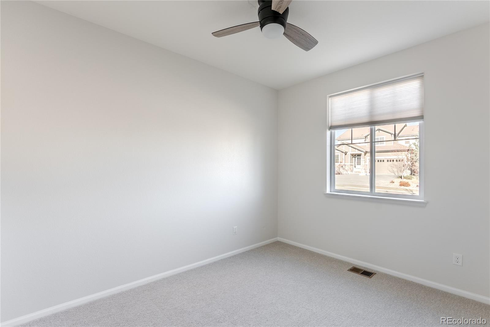 602 Mathews Way Erie, CO 80516 - Photo 23 of 50 an empty room with a window and a fan