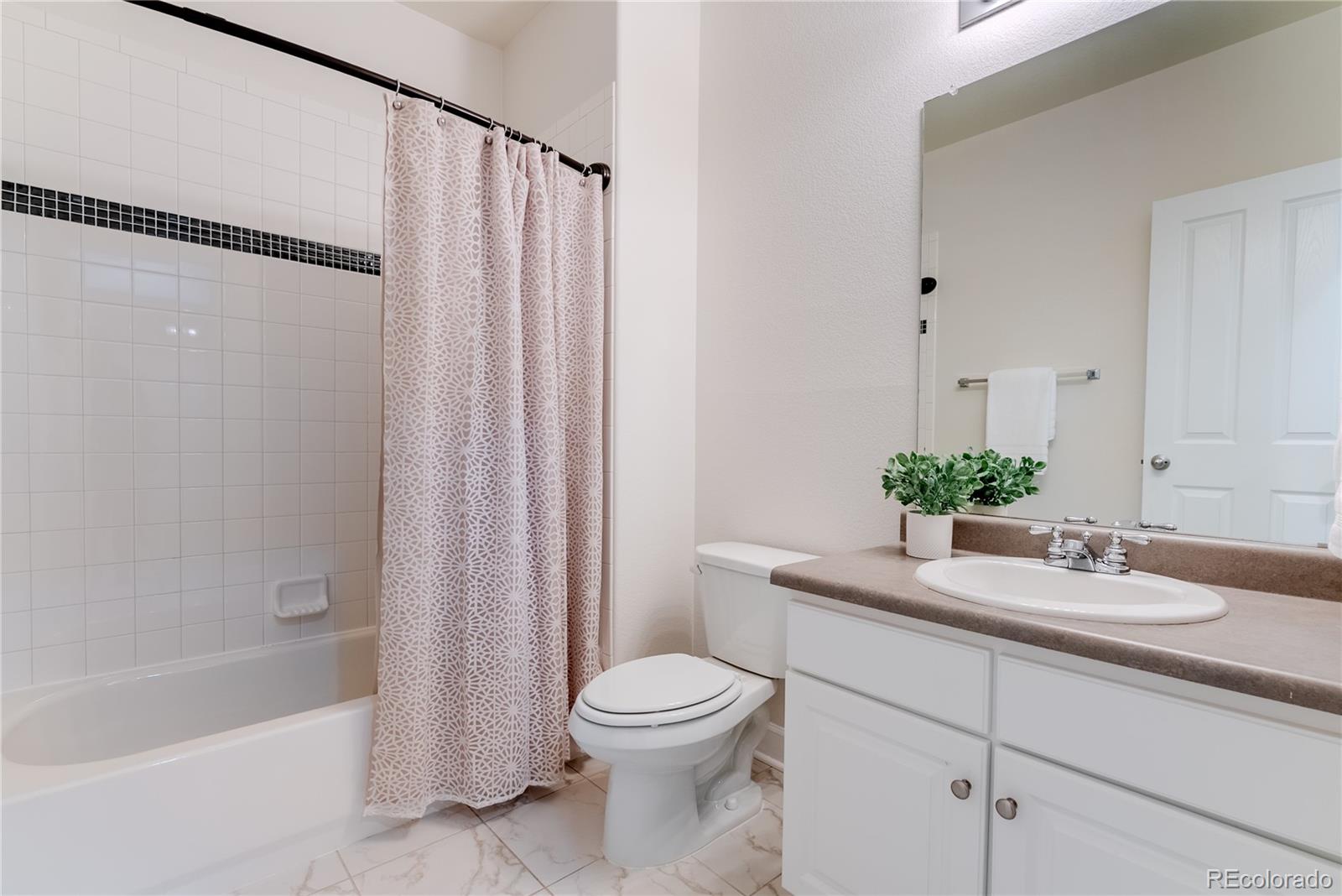 602 Mathews Way Erie, CO 80516 - Photo 38 of 50 a bathroom with a sink a toilet and shower