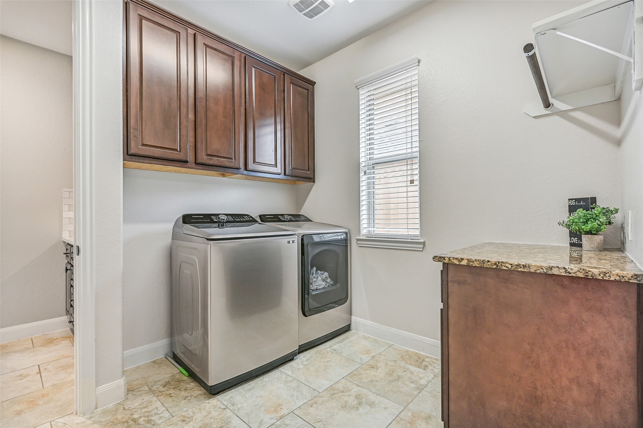 1008 Point Isabel Lane Friendswood, TX 77546 - Photo 33 of 50 A highly functional feature, the primary suite connects directly to the utility room just beyond the bath, complete with cabinetry, folding space, and room for full size appliances.