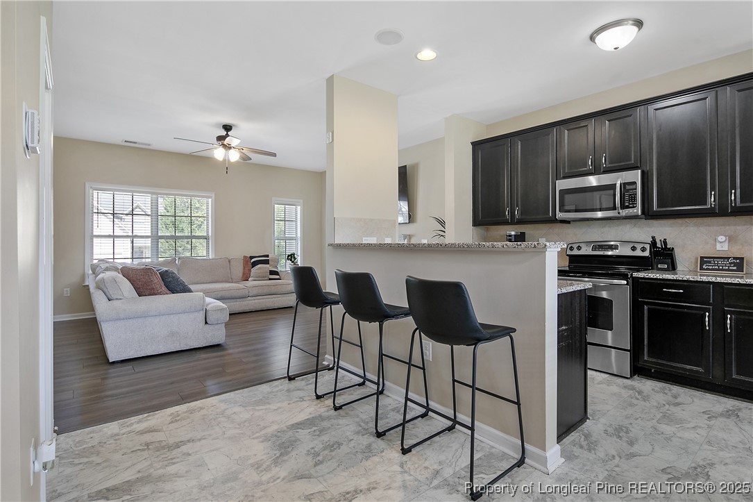 21 Bicentennial Way Cameron, NC 28326 - Photo 15 of 50 a large kitchen with cabinets appliances and a dining table
