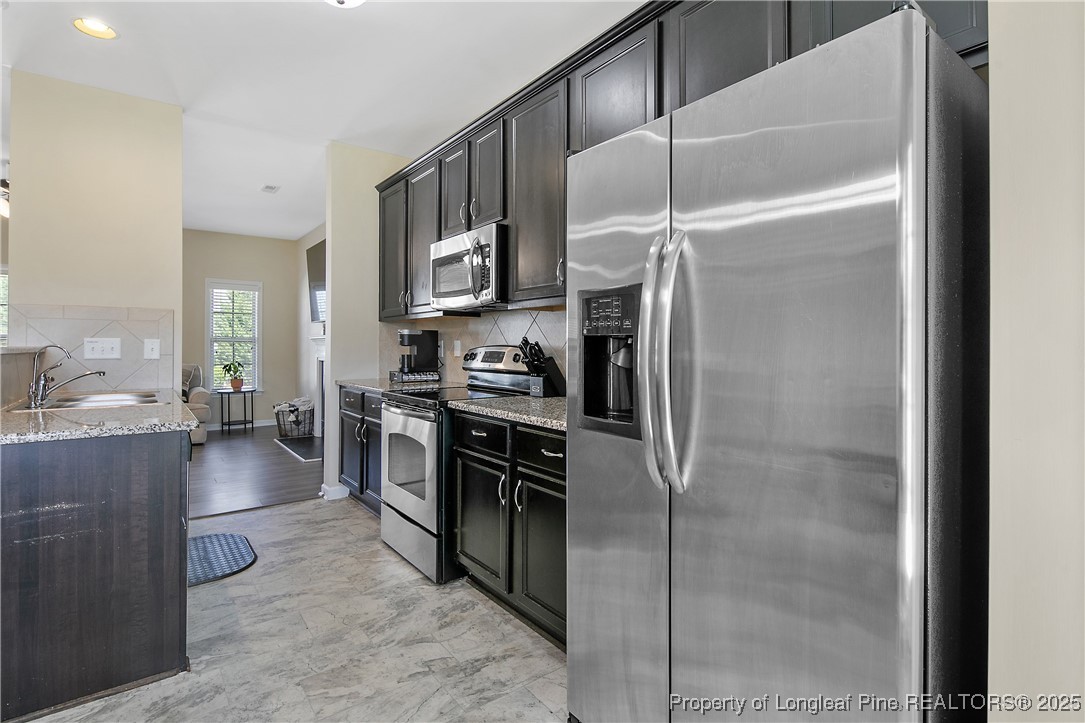 21 Bicentennial Way Cameron, NC 28326 - Photo 22 of 50 a kitchen with stainless steel appliances a refrigerator and a stove top oven