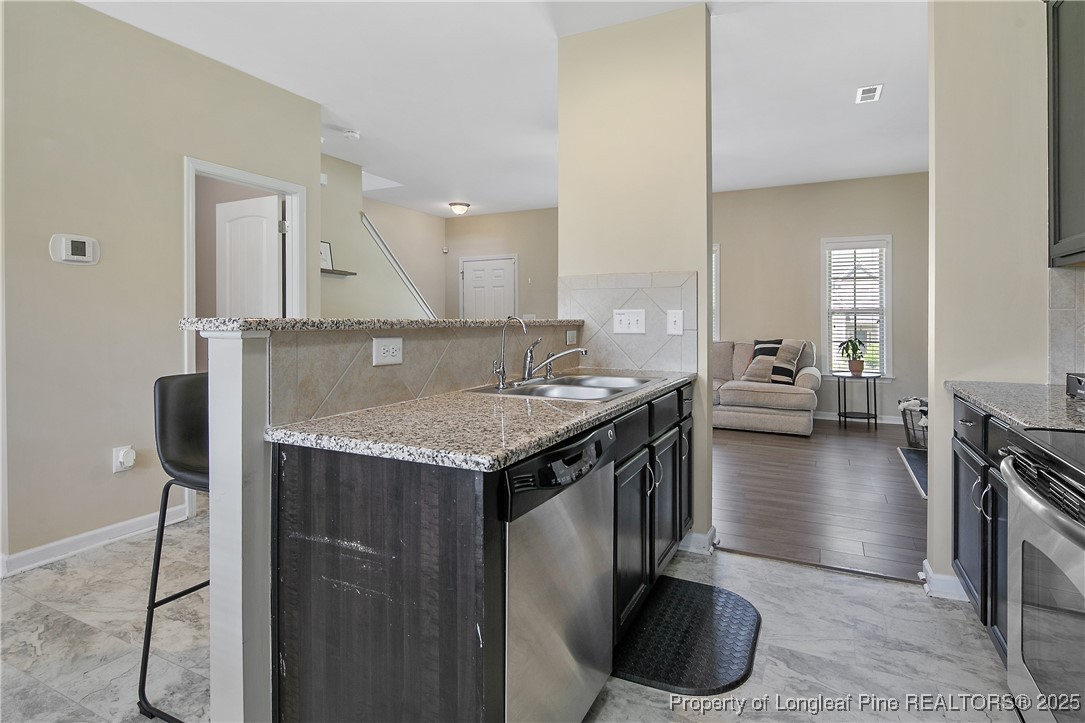 21 Bicentennial Way Cameron, NC 28326 - Photo 24 of 50 a kitchen with a table and chairs in it