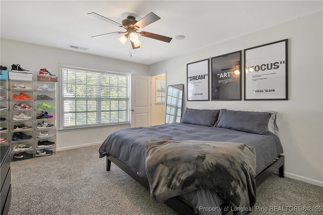 21 Bicentennial Way Cameron, NC 28326 - Photo 29 of 50 a spacious bedroom with a bed and a large window
