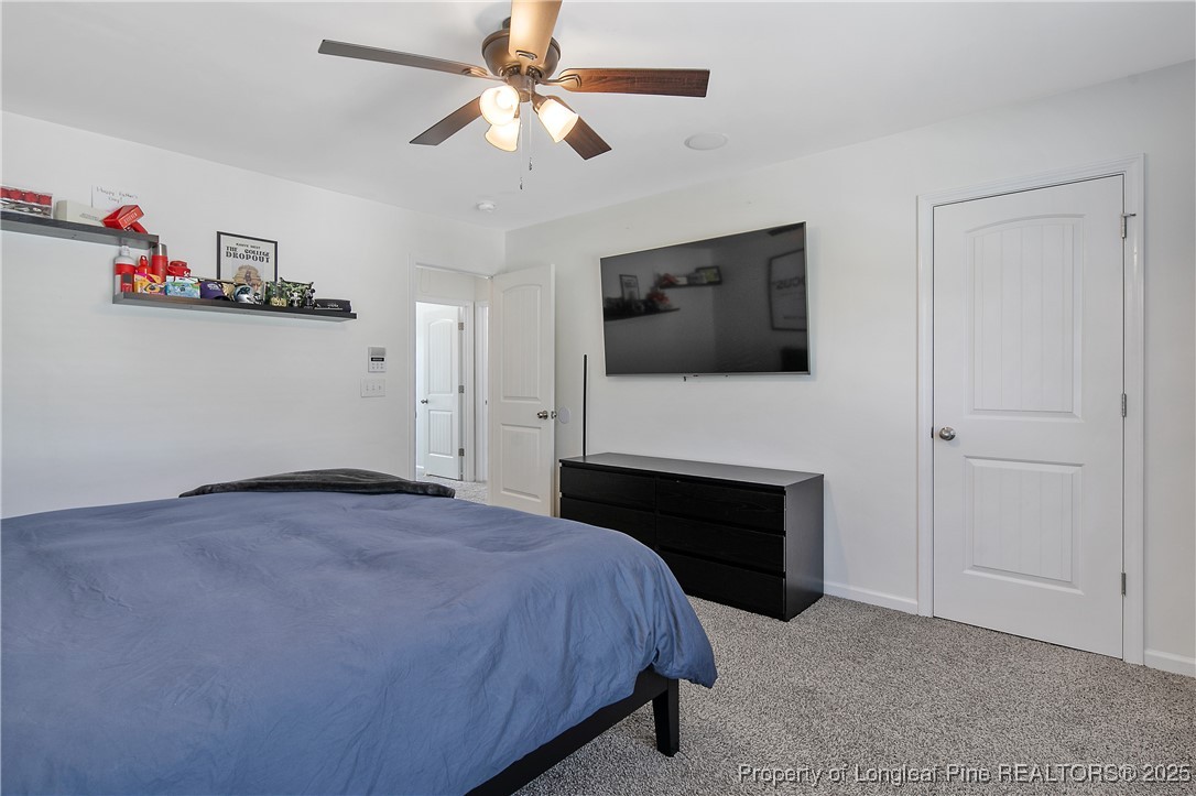 21 Bicentennial Way Cameron, NC 28326 - Photo 31 of 50 a bedroom with a bed and a flat screen tv