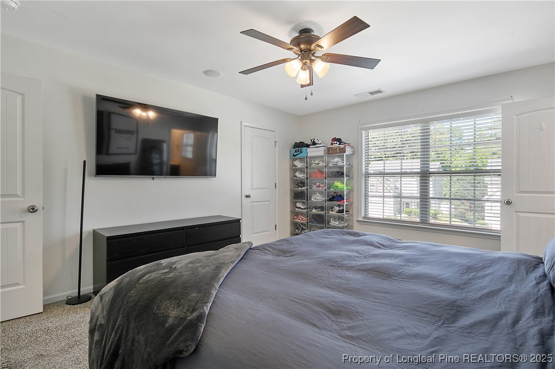 21 Bicentennial Way Cameron, NC 28326 - Photo 32 of 50 a bedroom with a bed a flat screen tv and a window