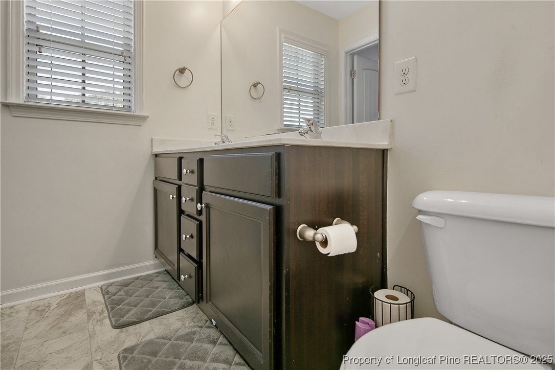 21 Bicentennial Way Cameron, NC 28326 - Photo 34 of 50 a bathroom with a sink mirror and toilet