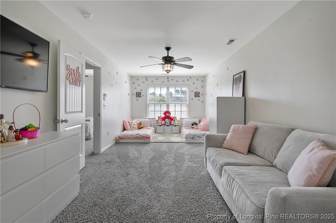 21 Bicentennial Way Cameron, NC 28326 - Photo 44 of 50 a living room with furniture a flat screen tv and a chandelier
