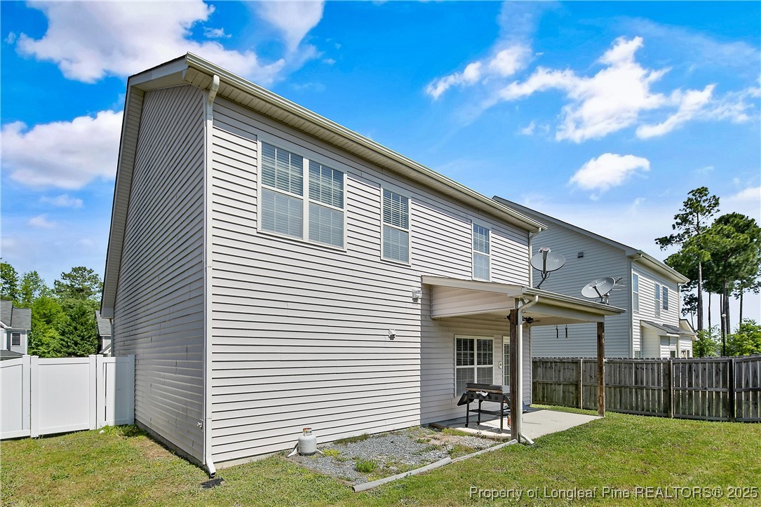 21 Bicentennial Way Cameron, NC 28326 - Photo 49 of 50 a view of a white house with a yard and plants