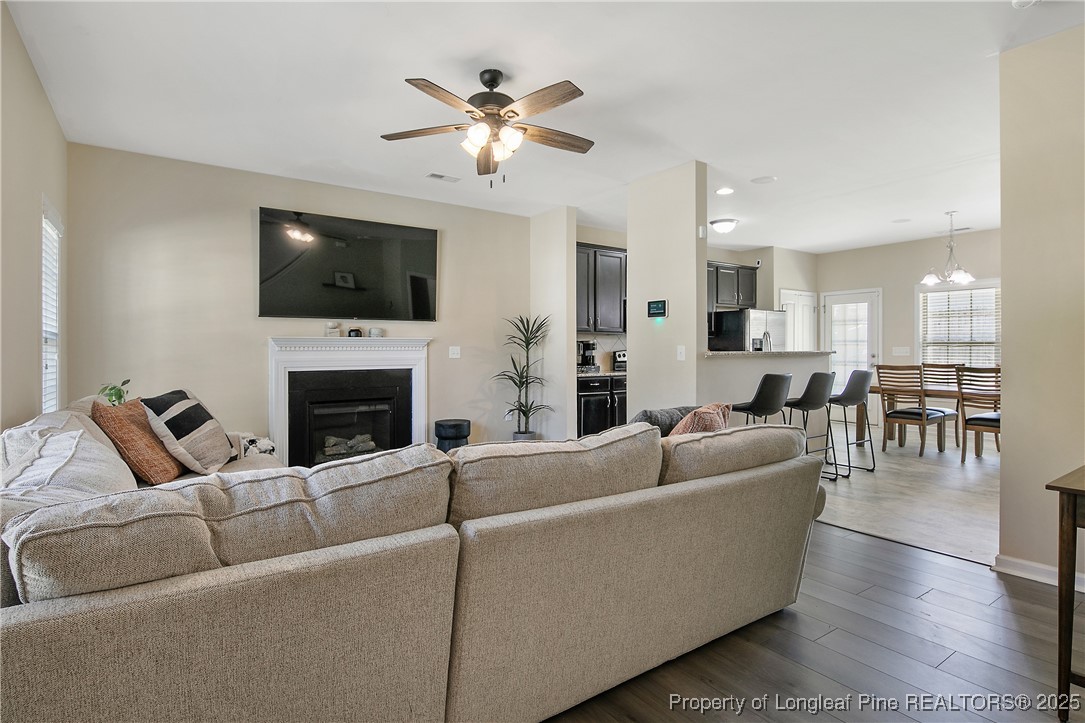 21 Bicentennial Way Cameron, NC 28326 - Photo 6 of 50 a living room with furniture a flat screen tv and a fireplace