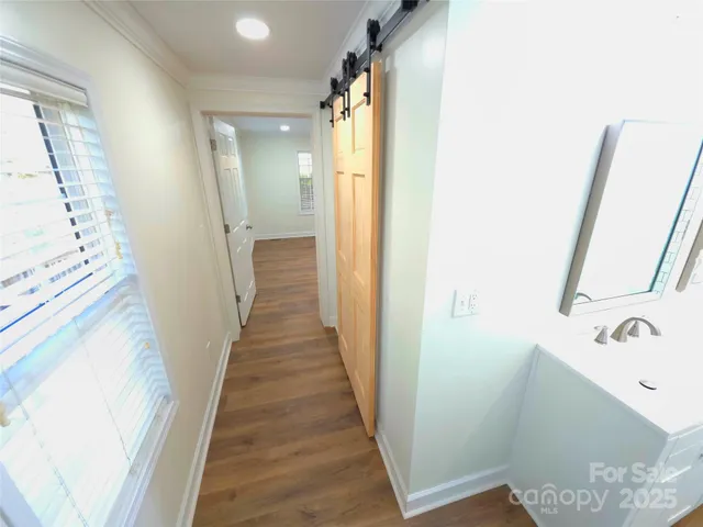 a view of a bathroom from a hallway