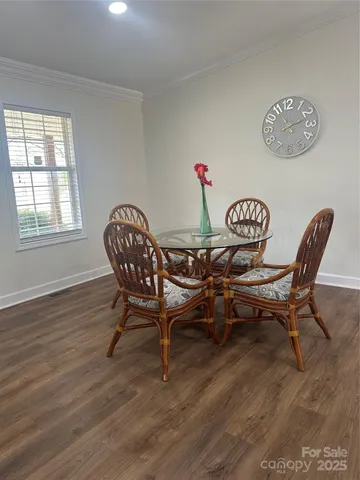 a view of a dining room with furniture wooden floor and a window