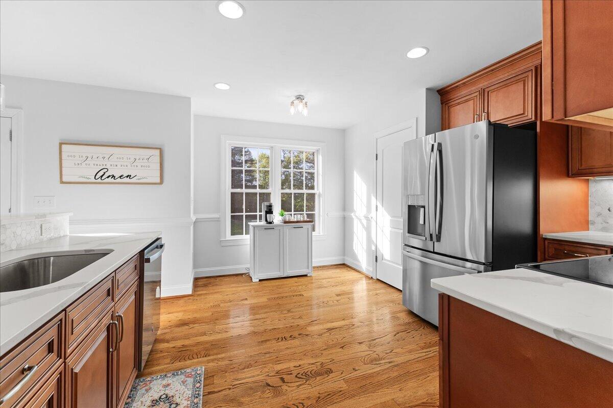 1695 Red Ln Extension Salem, VA 24153 - Photo 14 of 41 a kitchen with stainless steel appliances granite countertop a refrigerator a stove and a sink with wooden floors