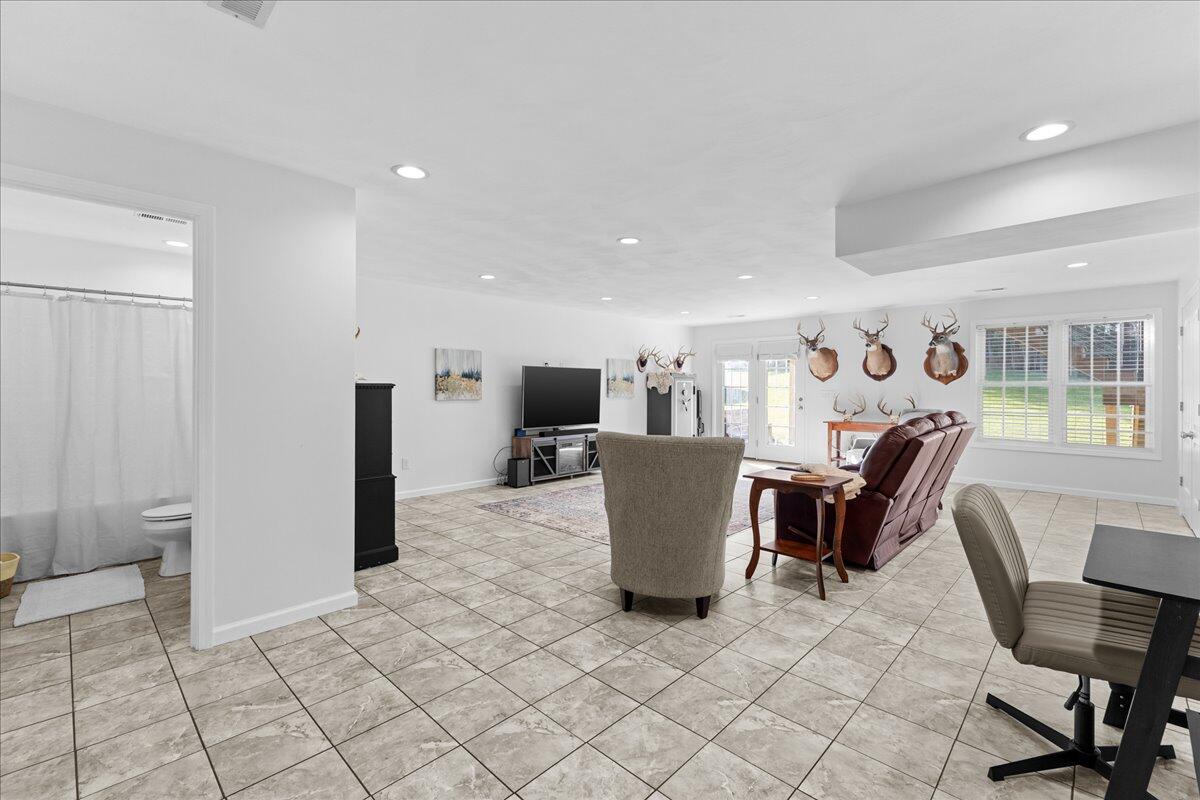 1695 Red Ln Extension Salem, VA 24153 - Photo 32 of 41 a living room with furniture a dining table and a refrigerator with wooden floor