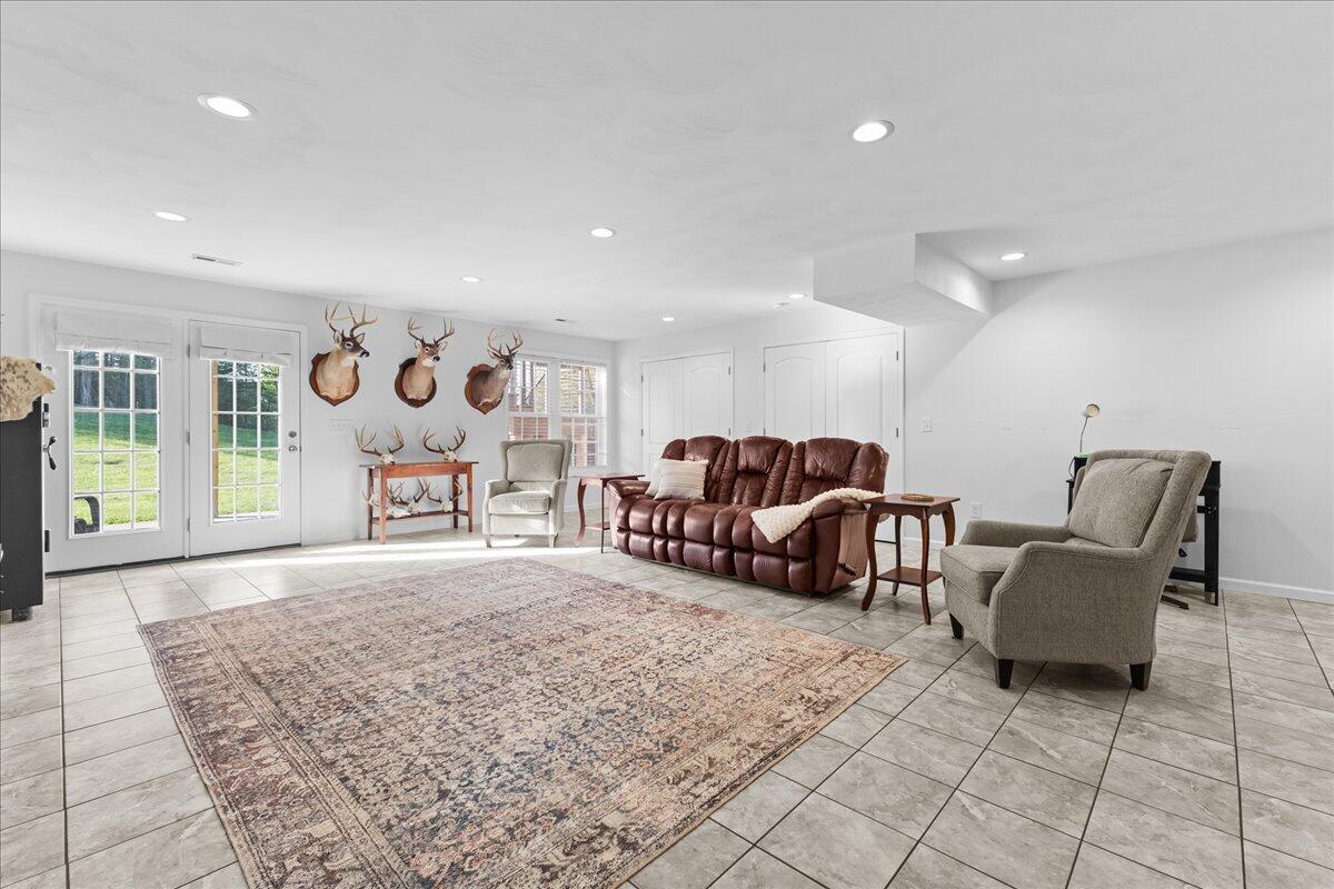 1695 Red Ln Extension Salem, VA 24153 - Photo 35 of 41 a spacious bedroom with a bed a couch and a table in it