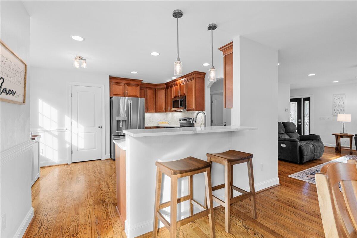 1695 Red Ln Extension Salem, VA 24153 - Photo 8 of 41 a kitchen with stainless steel appliances granite countertop a sink a stove a refrigerator and island with wooden floor