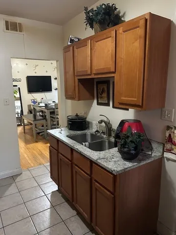 a kitchen with stainless steel appliances a sink a microwave a stove and cabinets