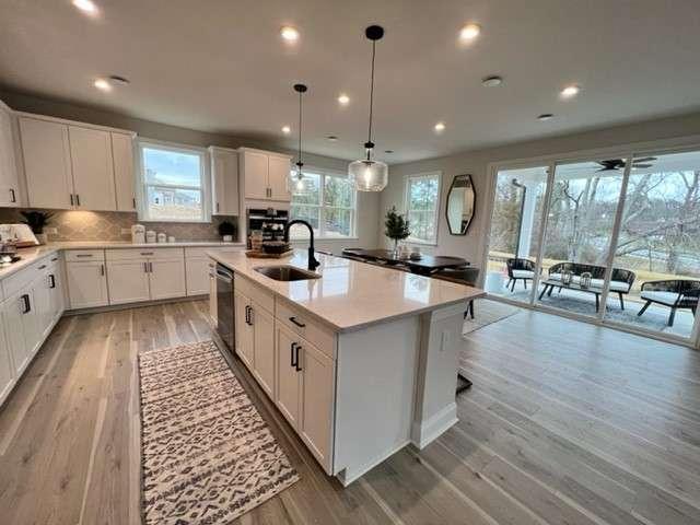 2418 Hidden Creek Road Kennesaw, GA 30152 - Photo 1 of 1 a large white kitchen with a large window a sink and stainless steel appliances