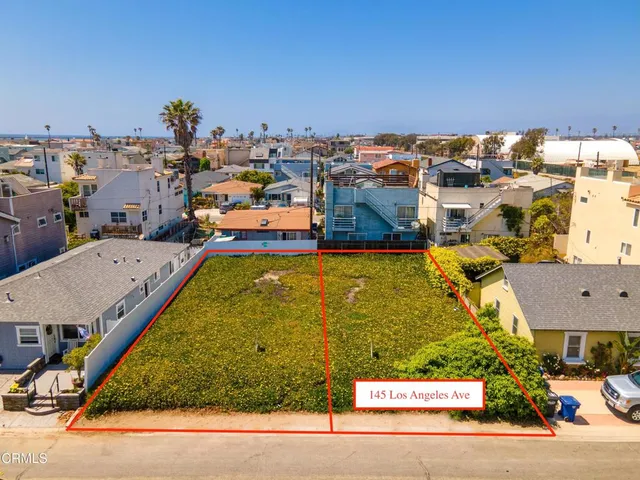 an aerial view of a ocean and city