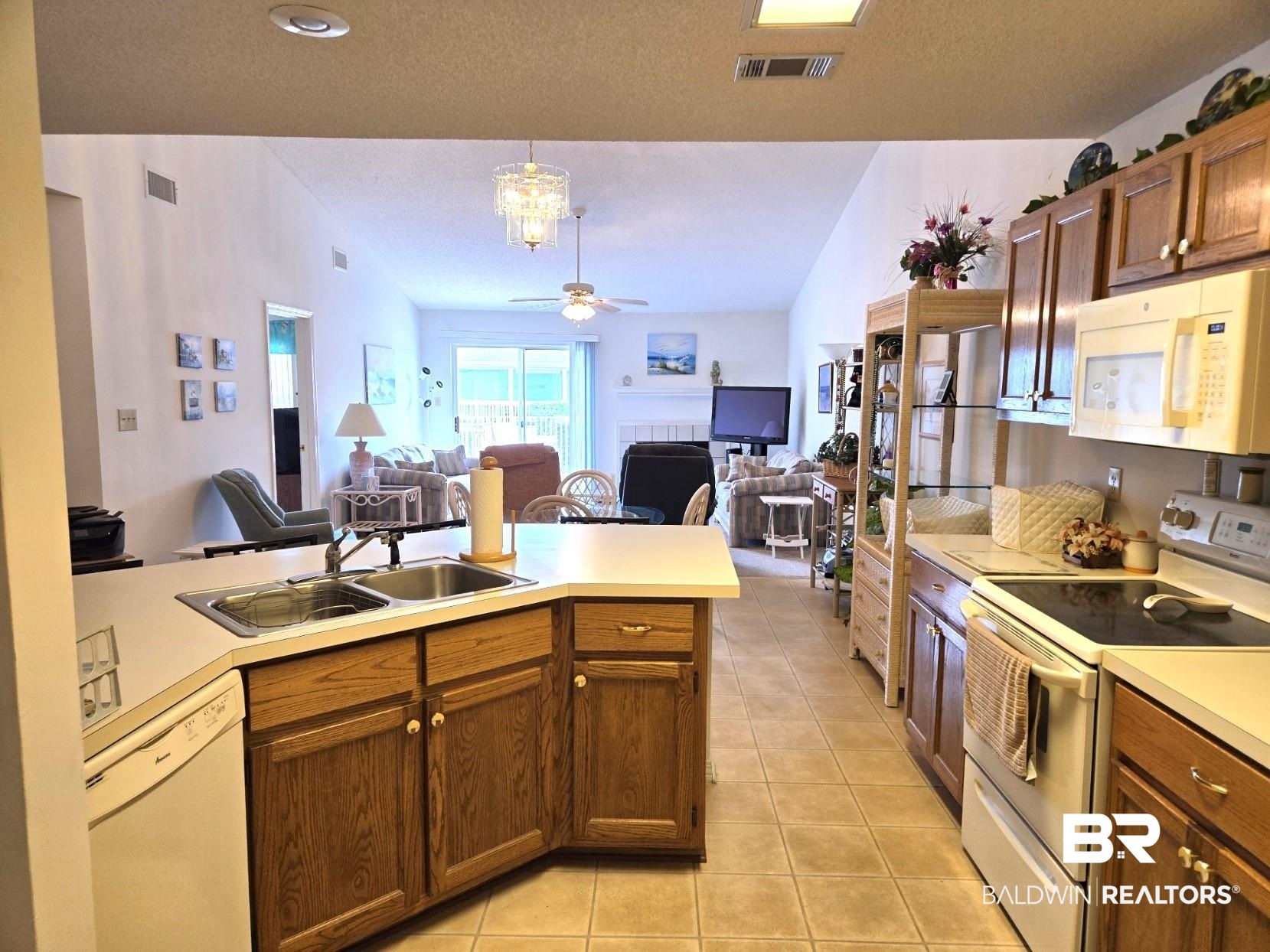 3200 Loop Road, Unit 87 Orange Beach, AL 36561 - Photo 18 of 46 Kitchen with white appliances, sink, light tile patterned floors, lofted ceiling, and ceiling fan