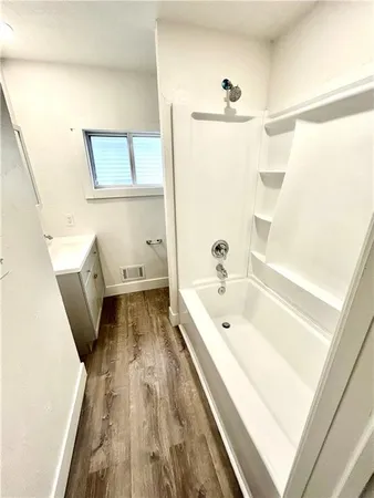 a bathroom with a bathtub and a shower
