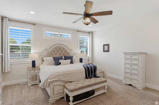 10676 Urban Rdg Cove South Jordan, UT 84095 - Photo 10 of 48 Carpeted bedroom featuring white walls and a large window with plantation shutters