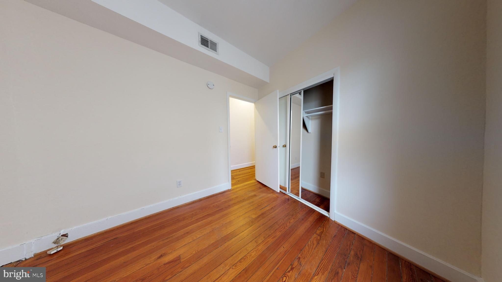 1307 22nd Street Northwest Washington, DC 20037 - Photo 12 of 46 a view of an empty room with wooden floor and closet