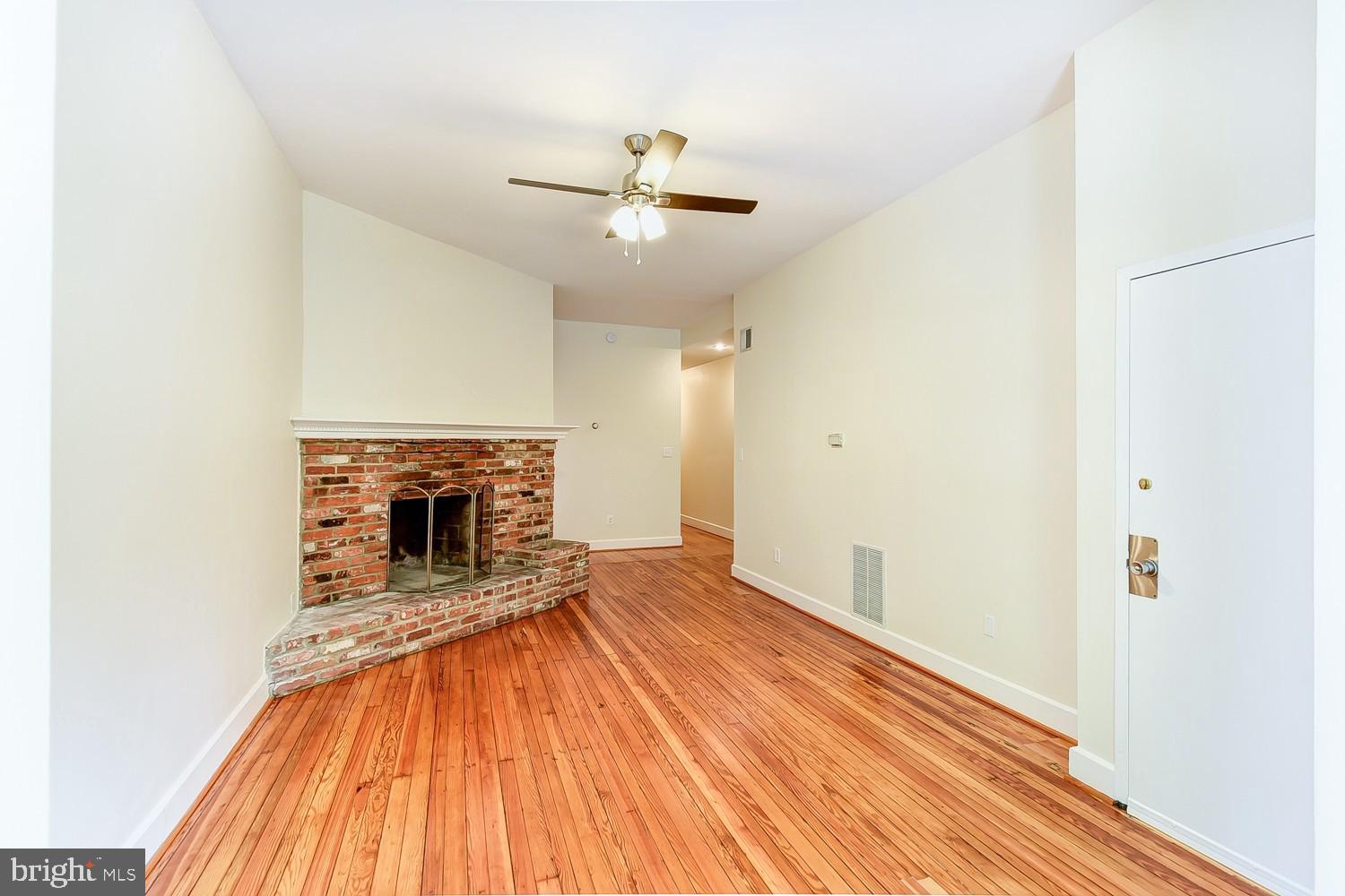 1307 22nd Street Northwest Washington, DC 20037 - Photo 17 of 46 a view of a livingroom with wooden floor a ceiling fan and kitchen