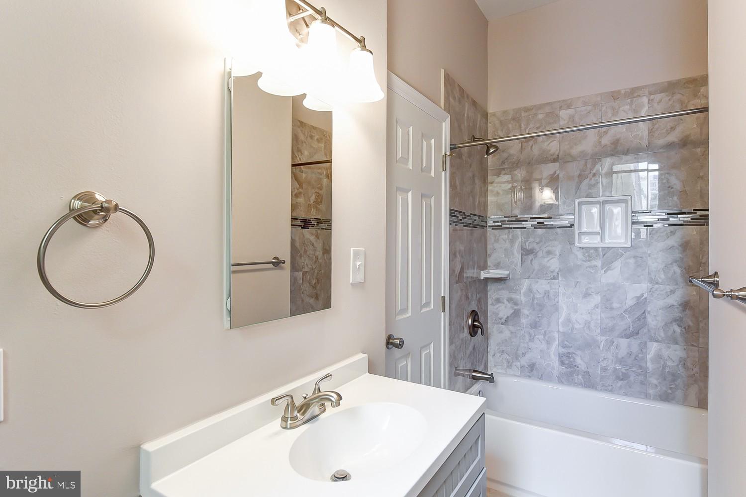 1307 22nd Street Northwest Washington, DC 20037 - Photo 19 of 46 a bathroom with a sink a mirror and a bathtub