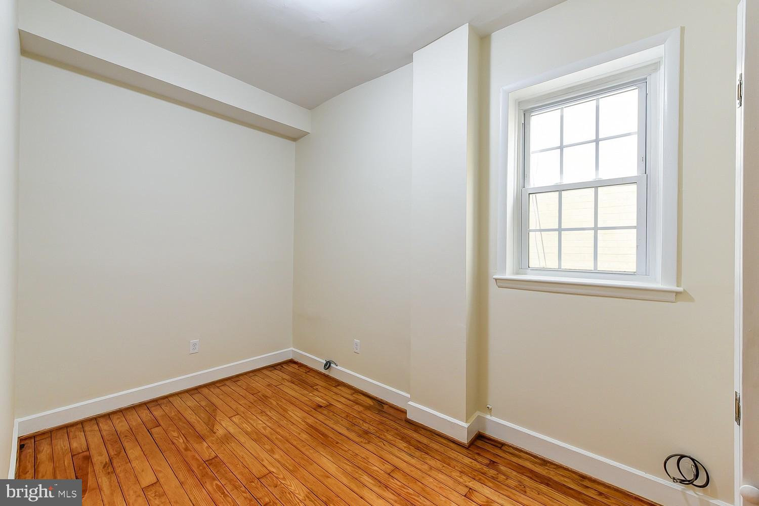 1307 22nd Street Northwest Washington, DC 20037 - Photo 24 of 46 a view of empty room with wooden floor and fan