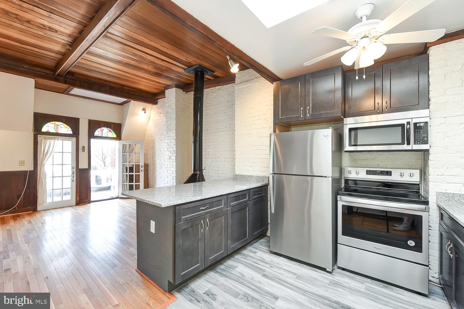 1307 22nd Street Northwest Washington, DC 20037 - Photo 29 of 46 a kitchen with stainless steel appliances granite countertop a refrigerator a stove and a wooden floors