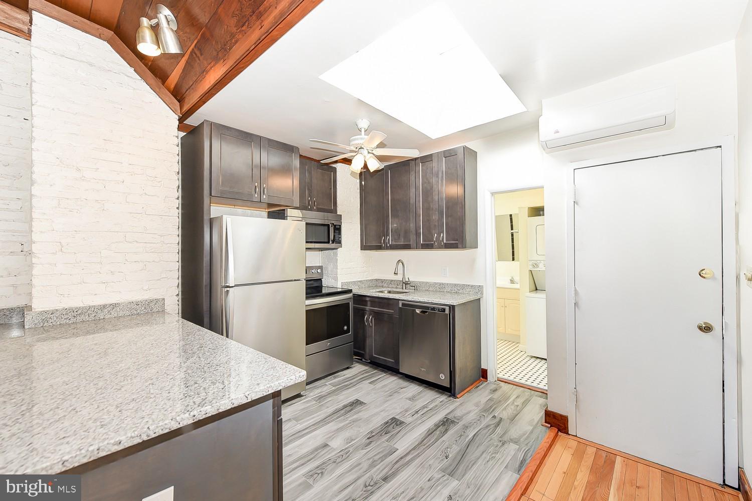 1307 22nd Street Northwest Washington, DC 20037 - Photo 31 of 46 a kitchen with granite countertop a refrigerator and a sink