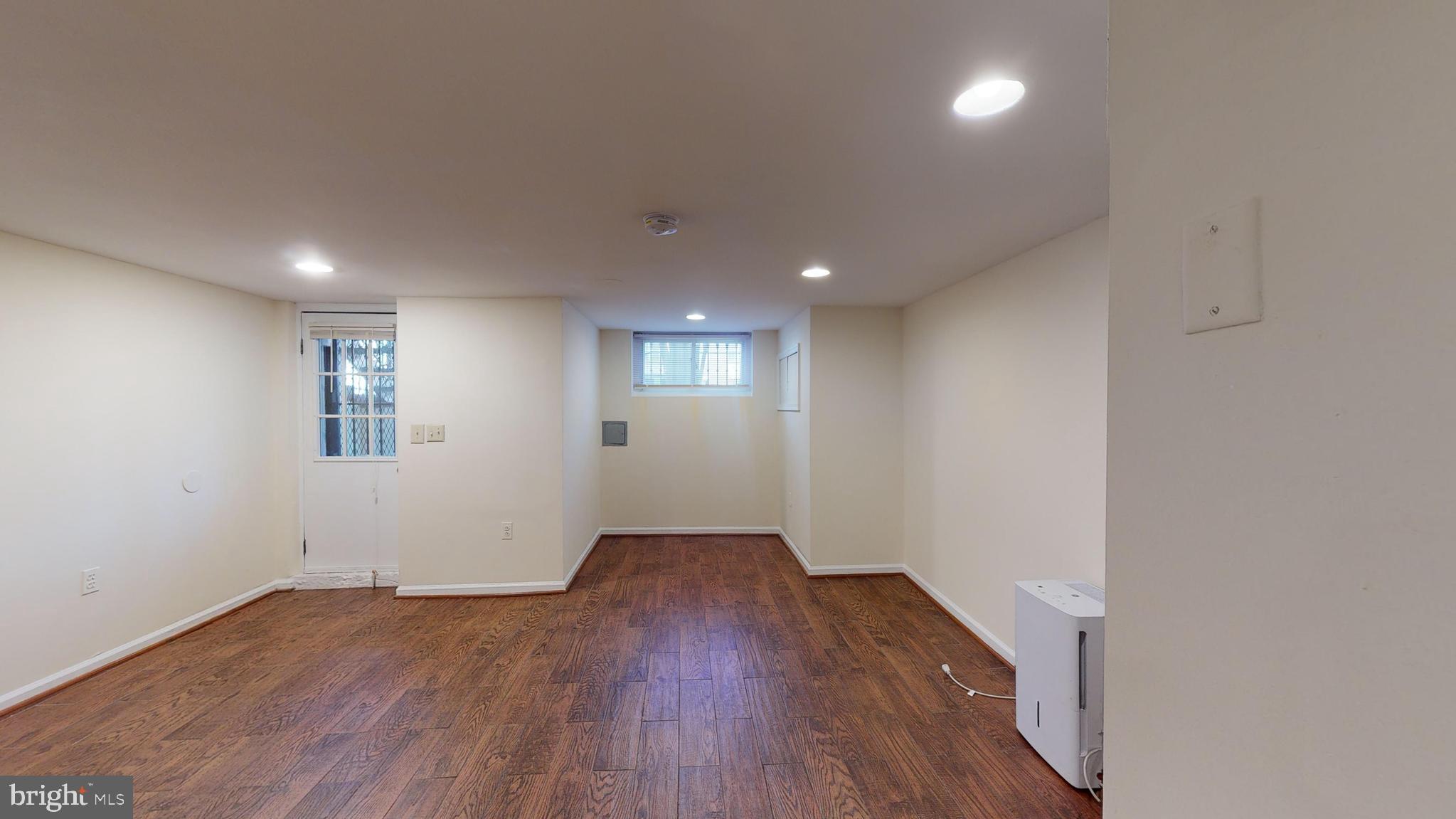 1307 22nd Street Northwest Washington, DC 20037 - Photo 39 of 46 an empty room with wooden floor and windows