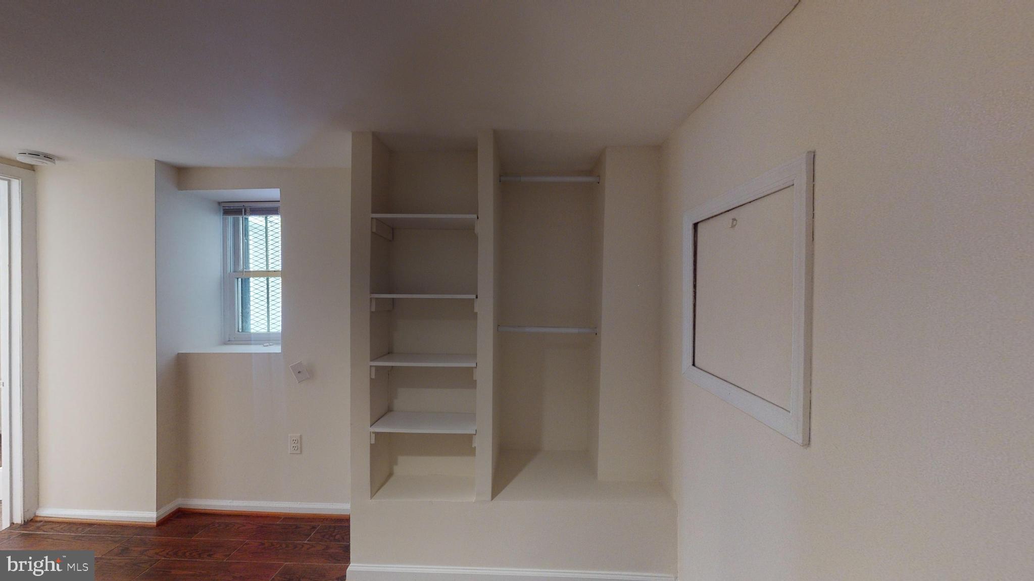 1307 22nd Street Northwest Washington, DC 20037 - Photo 43 of 46 a view of walk in closet with empty racks