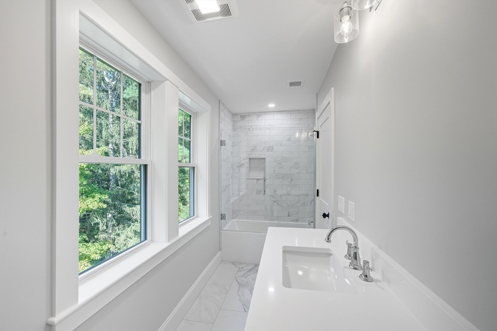 6 Ivy Circle Winchester, MA 01890 - Photo 26 of 40 a bathroom with a tub and window