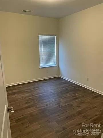 6100 Trinity Xing Circle Kannapolis, NC 28081 - Photo 9 of 25 a view of an empty room with wooden floor and a window