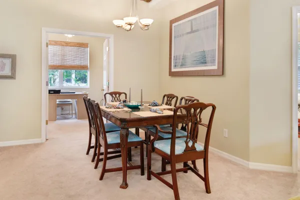 a view of a dining room with furniture and window