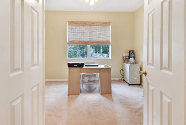a view of a livingroom with a fireplace and a window
