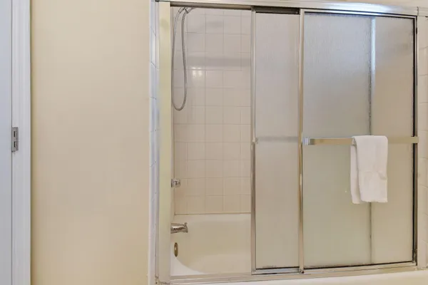 a bathroom with a glass shower door