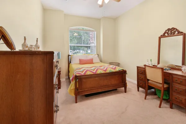 a bedroom with furniture and a window