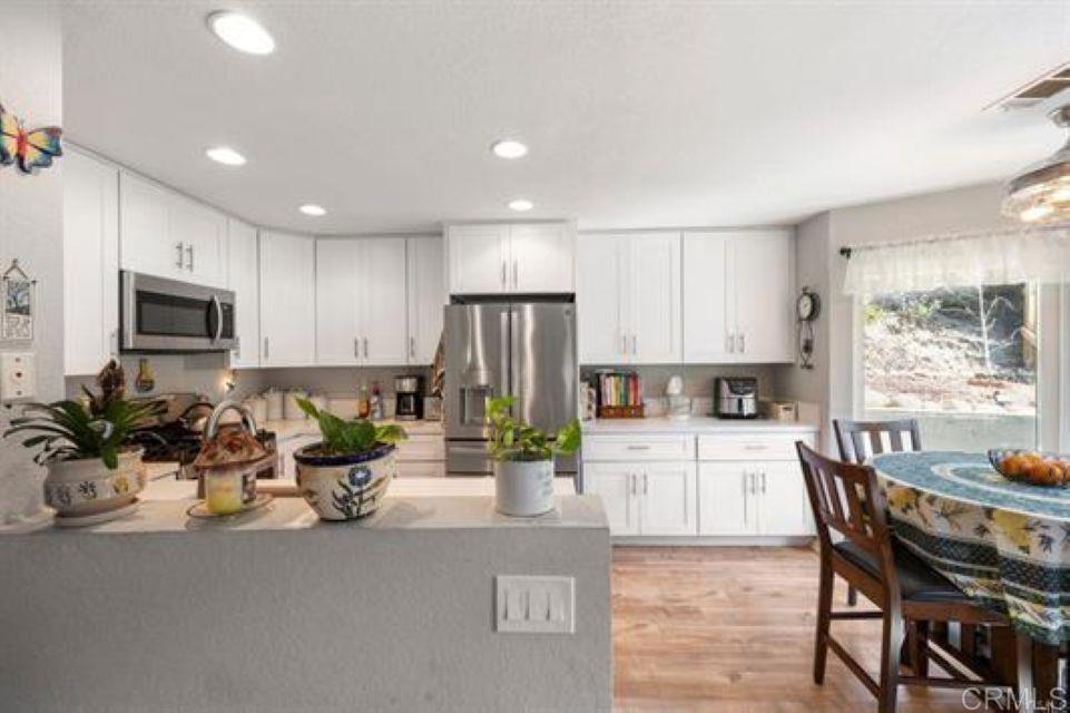 2277 Dunstan Street Oceanside, CA 92054 - Photo 11 of 36 a kitchen with sink a microwave and refrigerator