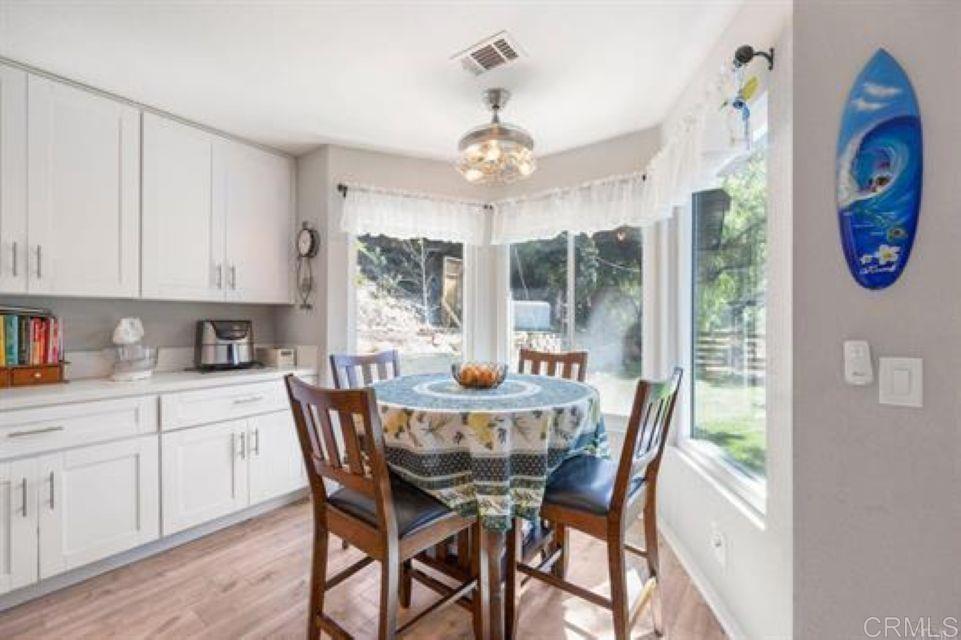 2277 Dunstan Street Oceanside, CA 92054 - Photo 12 of 36 a dining room with furniture a chandelier and window