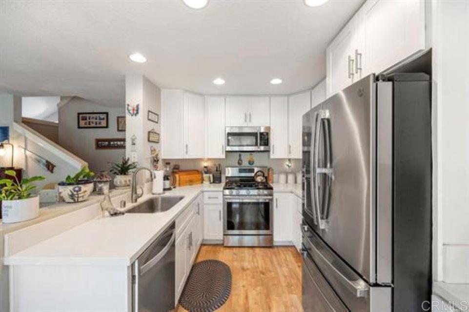 2277 Dunstan Street Oceanside, CA 92054 - Photo 13 of 36 a kitchen with stainless steel appliances granite countertop a refrigerator a stove and a sink