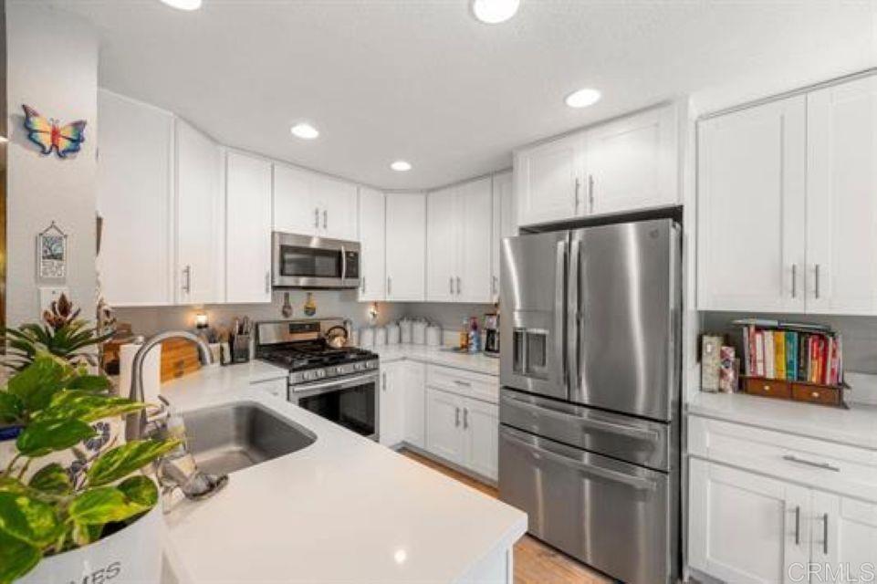 2277 Dunstan Street Oceanside, CA 92054 - Photo 14 of 36 a kitchen with granite countertop a refrigerator and a sink