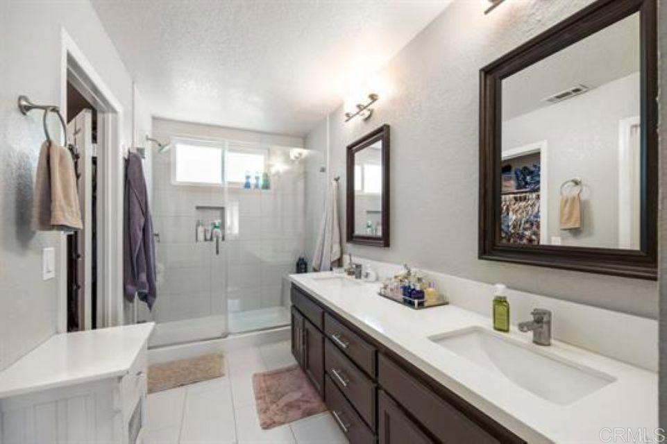 2277 Dunstan Street Oceanside, CA 92054 - Photo 18 of 36 a bathroom with a double vanity sink mirror double and shower