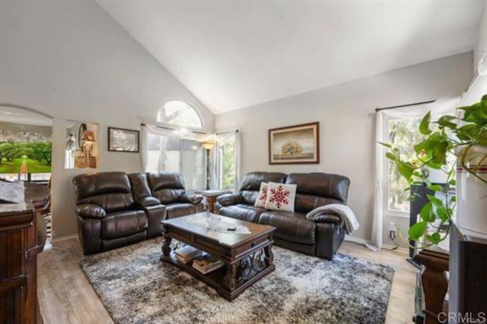 2277 Dunstan Street Oceanside, CA 92054 - Photo 2 of 36 a living room with furniture a chandelier and a potted plant