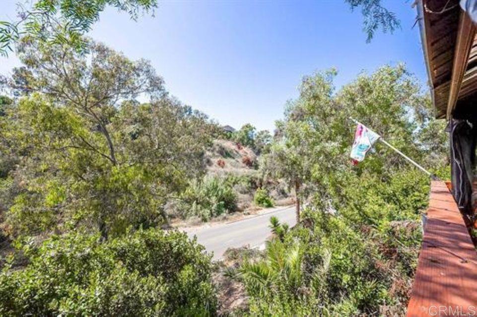 2277 Dunstan Street Oceanside, CA 92054 - Photo 28 of 36 a backyard of a house with lots of green space and trees all around